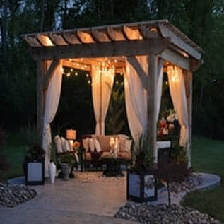 There is a concrete walkway with a lovely gazebo. 