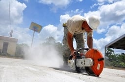  A worker saws through a concrete slab to separate the block.